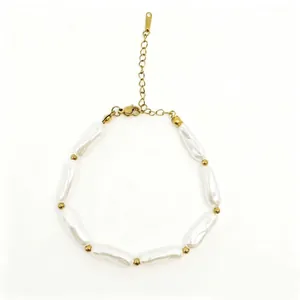 Detailed macro view of baroque pearl bracelet with gold spacer beads on white background