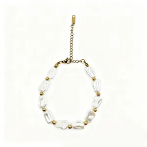 Detailed view of irregular baroque pearl bracelet featuring gold spacer beads and chain