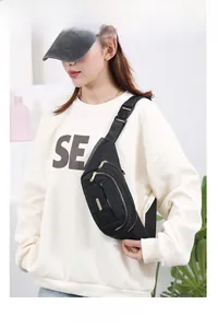 Model wearing a black multi-layer nylon waist bag for women in a casual scene