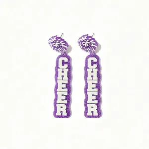 Detail of purple glitter acrylic earrings featuring white CHEER letter print design