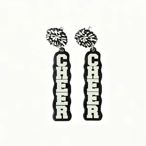 Close-up view of black acrylic earrings with white Cheer text and pom-pom details