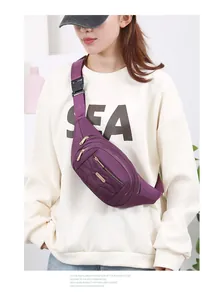 Close-up of a fashionable purple multi-layer waist bag worn by a model in a studio