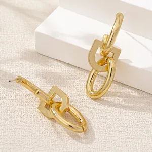 Minimalist gold geometric drop earrings featuring interlocking oval and U-shaped chain links