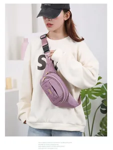 Stylish purple quilted waist bag worn crossbody by a model in a casual outfit.