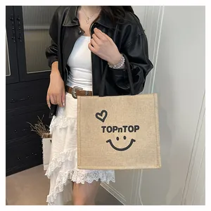 Stylish burlap shopping bag featuring a TOPnTOP smiley print and durable jute material