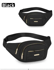 Detailed view of fashionable black multi-layered waist bag with stylish golden zippers