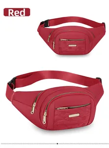 Close-up detail of the red fashionable multi-layer fanny pack with golden zippers