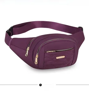 Side view of purple multi-layer women's waist bag with quilted detail and gold zippers
