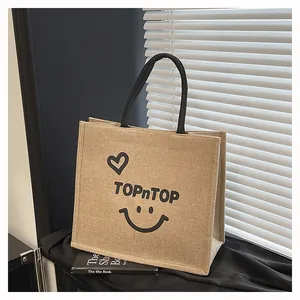 Eco-friendly large jute tote bag with TOPnTOP print and smiley face for daily commute.