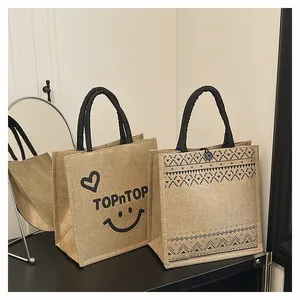 Detailed view of eco-friendly jute tote bags with printed patterns and handles