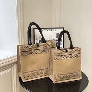 Pair of stylish natural jute tote bags with black tribal geometric print and handles