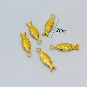 Detailed close-up view of small gold-tone fish pendants with a 2cm length measurement