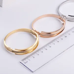 Three-color titanium steel bracelets with rhinestones shown with a size ruler