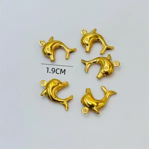 Macro view of five 1.9cm golden dolphin pendants for ocean-themed DIY jewelry accessories