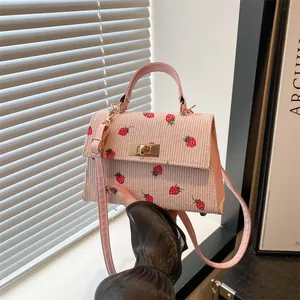 Stylish pink corduroy handbag with cute strawberry print and gold-tone clasp