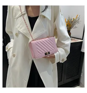 Elegant pink quilted crossbody bag with stylish metal lock and chain strap for women