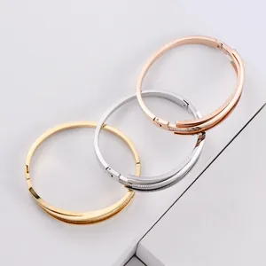 Detailed view of titanium steel bangles in three colors with delicate rhinestone inlay