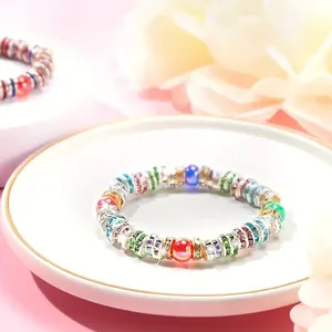 Close-up detail of colorful 6mm and 8mm rhinestone spacer beads in a beaded bracelet