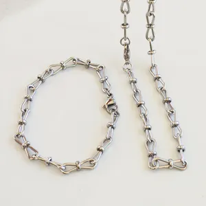 Detailed macro shot of stainless steel figure-8 link chain jewelry necklace and bracelet