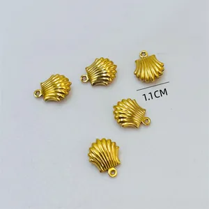 Close-up detail of 1.1cm gold scallop shell charms for DIY jewelry necklace making