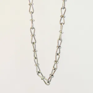 Detail of stainless steel 8-shape bow-knot link chain for minimalist jewelry designs.