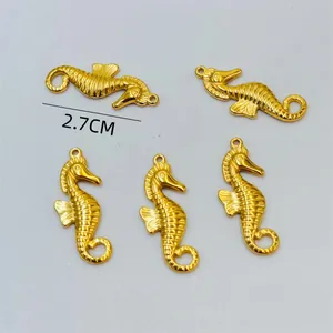 Detailed macro shot of five 2.7cm golden seahorse charms for DIY jewelry making