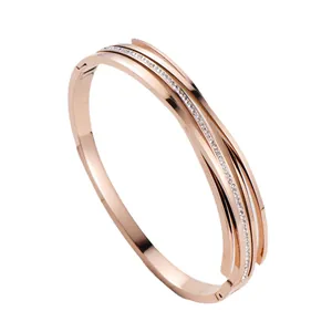 Elegant rose gold titanium steel bangle with sparkling rhinestone inlay and striped design