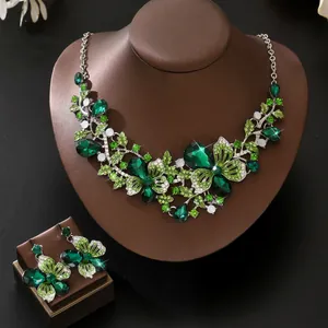 Detailed view of a vintage green crystal necklace and earrings butterfly set