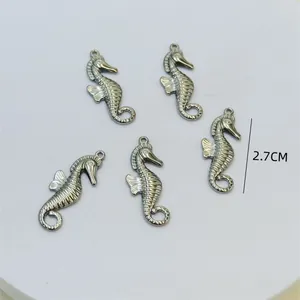 Close-up detail of five silver metal seahorse charms showing the 2.7cm height dimension