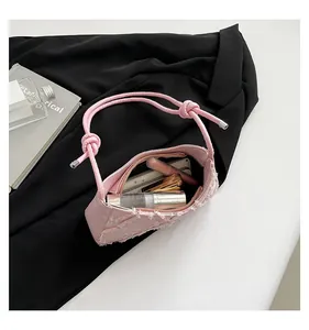 Interior detail of pink denim quilted shoulder bag showing makeup storage capacity