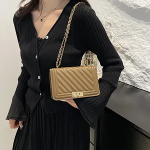 Classic v-quilted leather crossbody bag for women with gold chain strap and turn-lock closure