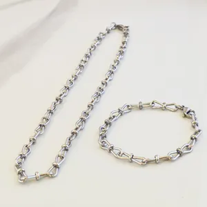 High-quality detailed shot of silver stainless steel figure-eight link jewelry set