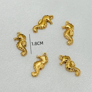 Detail view of five small golden seahorse charms for DIY jewelry making 1.8cm size