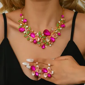 Detailed view of a vintage floral rhinestone jewelry set featuring vibrant pink crystals