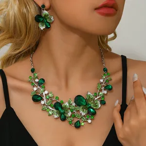 Close-up of vintage emerald green butterfly flower rhinestone jewelry set on model