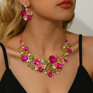 Detailed view of vintage fuchsia butterfly rhinestone jewelry set on model for weddings.
