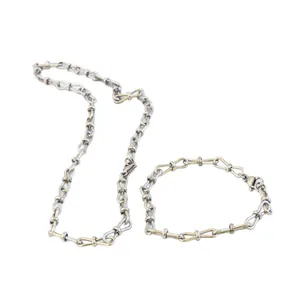 Stylish stainless steel jewelry set featuring unique figure-8 bow-tie link design.