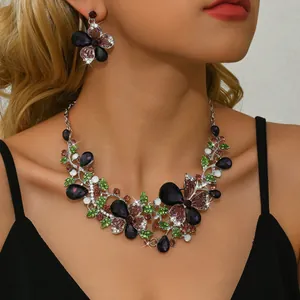 Close-up of vintage multi-color butterfly floral necklace and earrings jewelry set