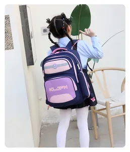 Back view of an Asian girl wearing a navy blue and pink backpack for school kids