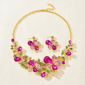 Ornate vintage-style jewelry set with pink butterfly and floral rhinestone details