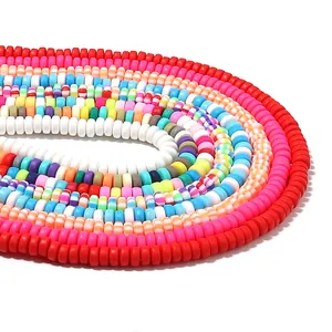 Close-up of colorful flat round polymer clay heishi beads for DIY jewelry making.