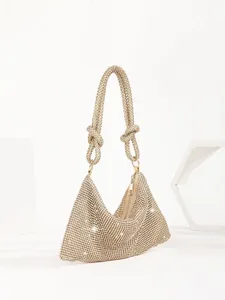 Elegant champagne gold rhinestone evening bag featuring knotted crystal handles.