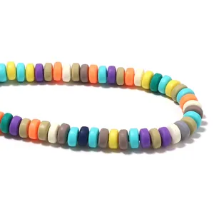 Close-up detail of colorful candy-colored flat round polymer clay spacer beads for DIY