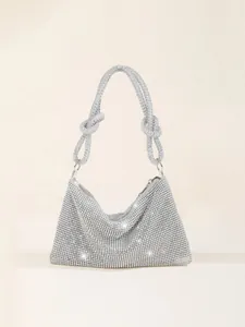 Detailed shot of sparkling silver rhinestone evening bag with elegant knotted handle