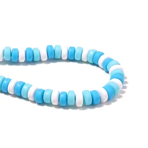 Macro view of blue and white polymer clay flat round spacer beads for DIY jewelry making
