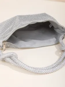 Detailed macro view of the silver rhinestone evening bag interior and zipper closure