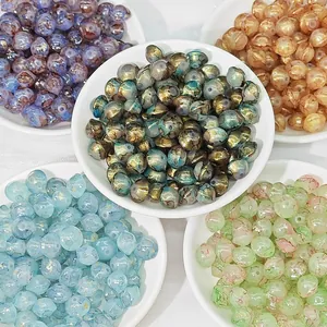 Close-up of assorted colorful 8x10mm glass beads in bowls for DIY jewelry crafts