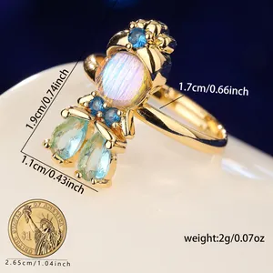 Detailed macro view of a princess moonstone ring showing dimensions and gold finish