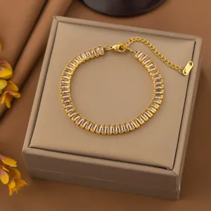 Detail view of a gold stainless steel bracelet with rectangular clear zircon stones