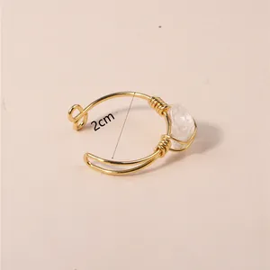 2cm diameter detail of a handmade gold wire-wrapped natural crystal open ring